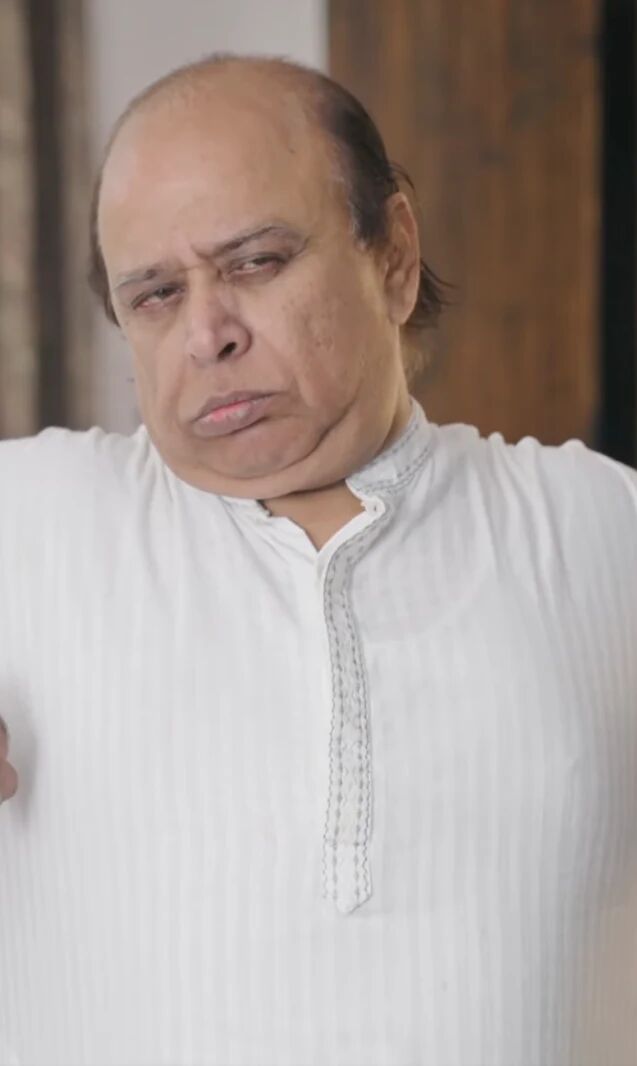 A man in a white kurta stretching his arms