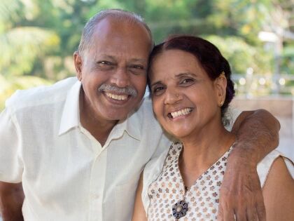 A smiling older couple standing together